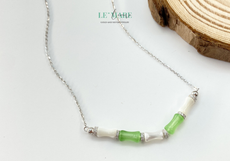 Vân Trúc lấy chính hình ảnh ấy làm nguồn cảm hứng. Những đường nét uốn cong mềm mại như gió, như mây, khẽ ôm lấy viên ngọc bích xanh ngát – biểu tượng của may mắn, bình an và sự sống. Tựa như chính người phụ nữ hiện đại: dịu dàng, nhẫn nại, nhưng kiên cường hơn bất kỳ ai.